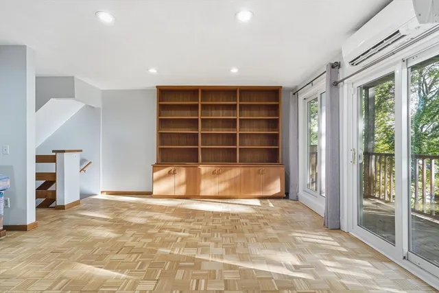 a view of an empty room with a empty shelves and wooden floor