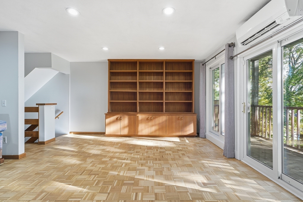 184 Rawson Road Brookline, MA 02445 - Photo 11 of 29 a view of an empty room with a empty shelves and wooden floor
