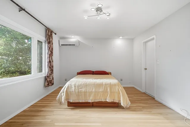 a view of a livingroom with wooden floor and ceiling fan