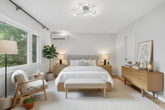 a living room with furniture potted plant and windows