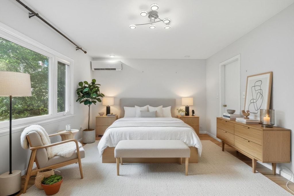 184 Rawson Road Brookline, MA 02445 - Photo 14 of 29 a living room with furniture potted plant and windows