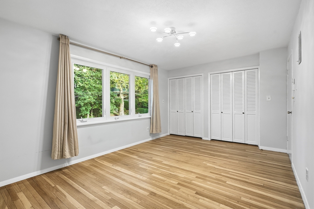 184 Rawson Road Brookline, MA 02445 - Photo 18 of 29 a view of empty room with wooden floor and fan