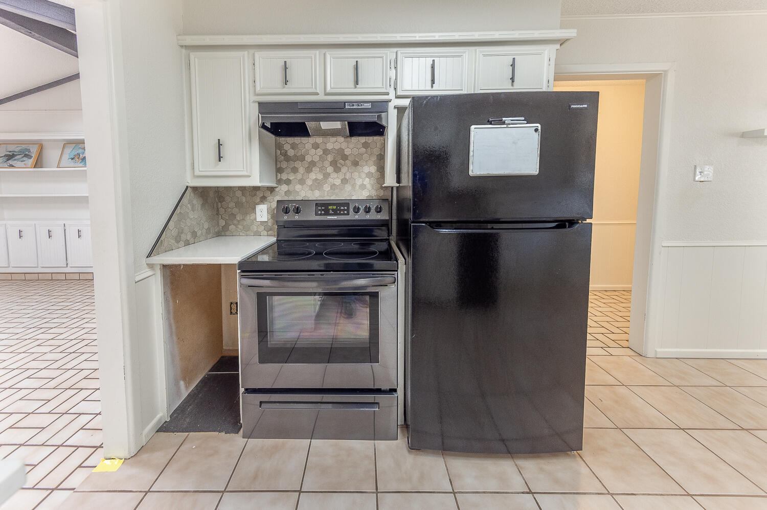 4706 78th Street Lubbock, TX 79424 - Photo 12 of 43 a kitchen with a stove and a refrigerator