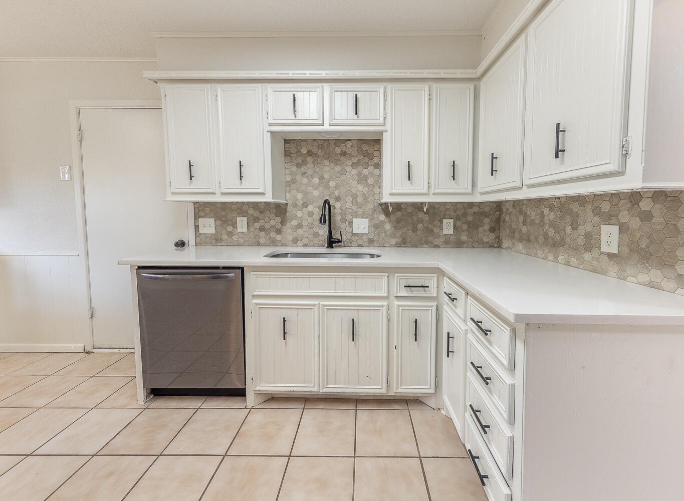 4706 78th Street Lubbock, TX 79424 - Photo 13 of 43 a kitchen with granite countertop white cabinets and white appliances