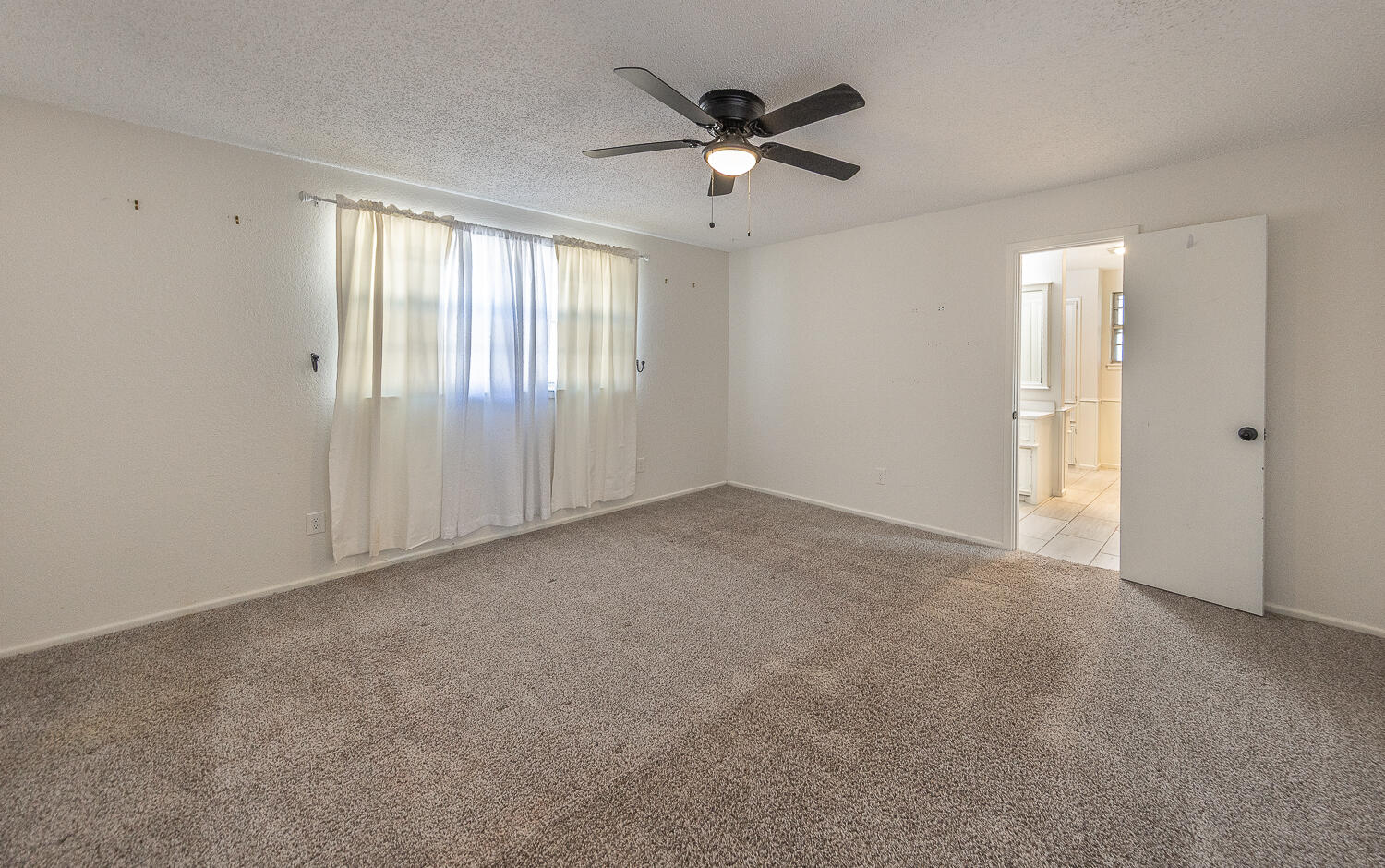 4706 78th Street Lubbock, TX 79424 - Photo 16 of 43 a view of an empty room with a window