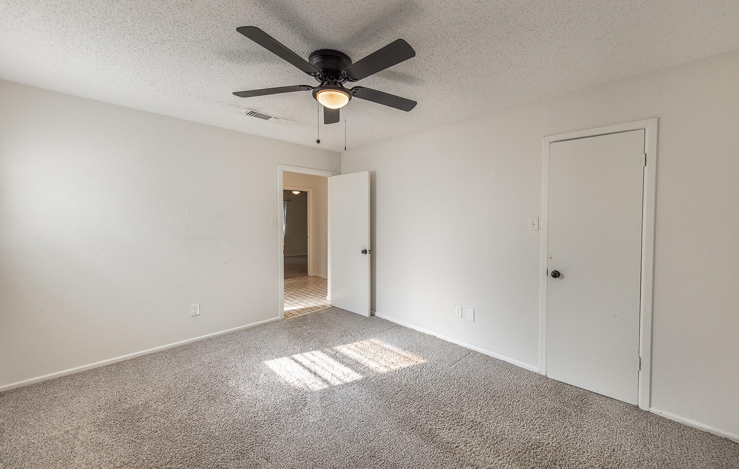 4706 78th Street Lubbock, TX 79424 - Photo 24 of 43 an empty room with a ceiling fan and a window