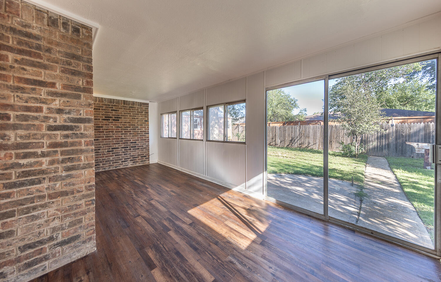 4706 78th Street Lubbock, TX 79424 - Photo 29 of 43 a view of empty room with wooden floor and floor to ceiling window