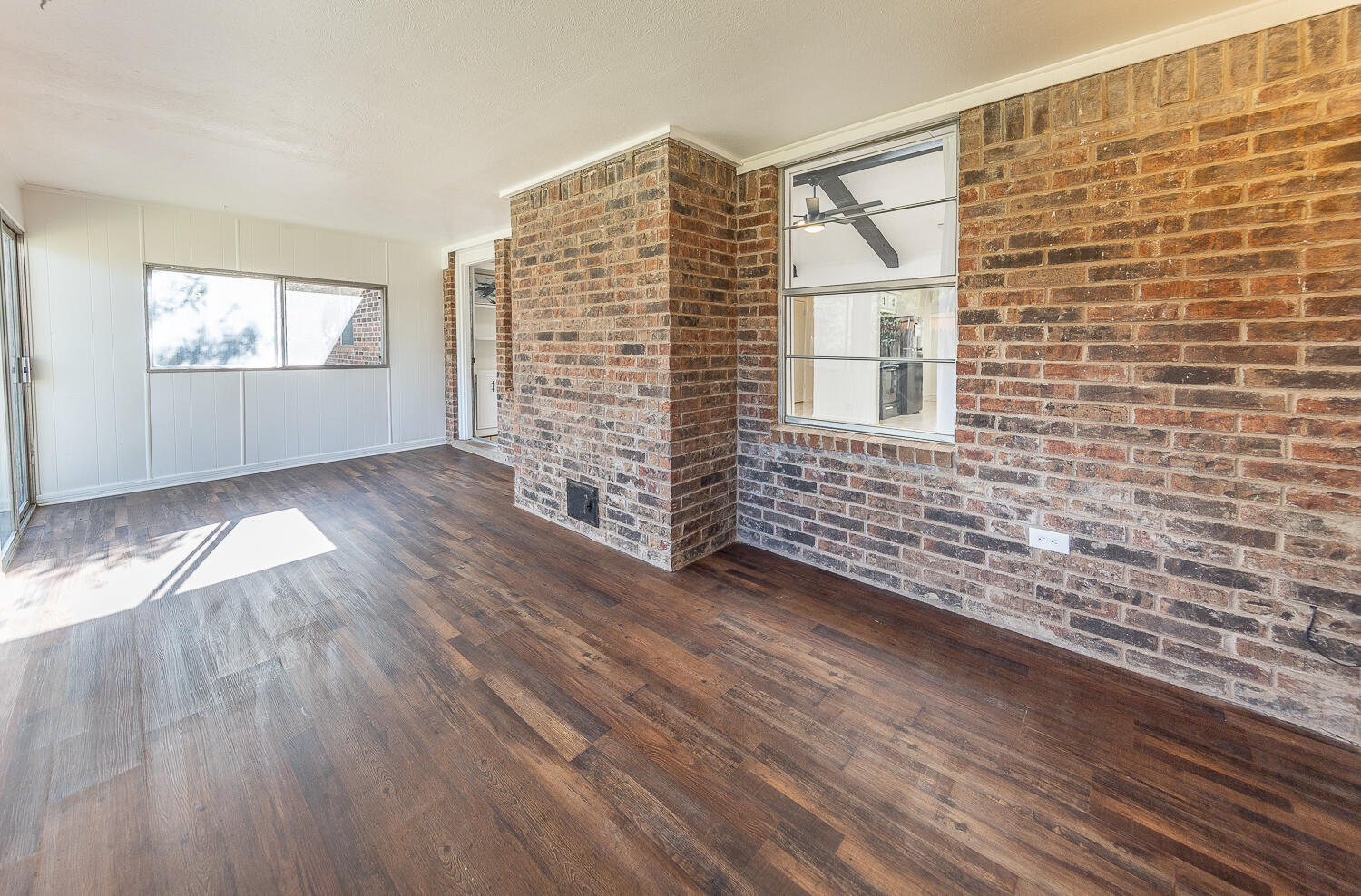 4706 78th Street Lubbock, TX 79424 - Photo 30 of 43 a view of an empty room with wooden floor and a window