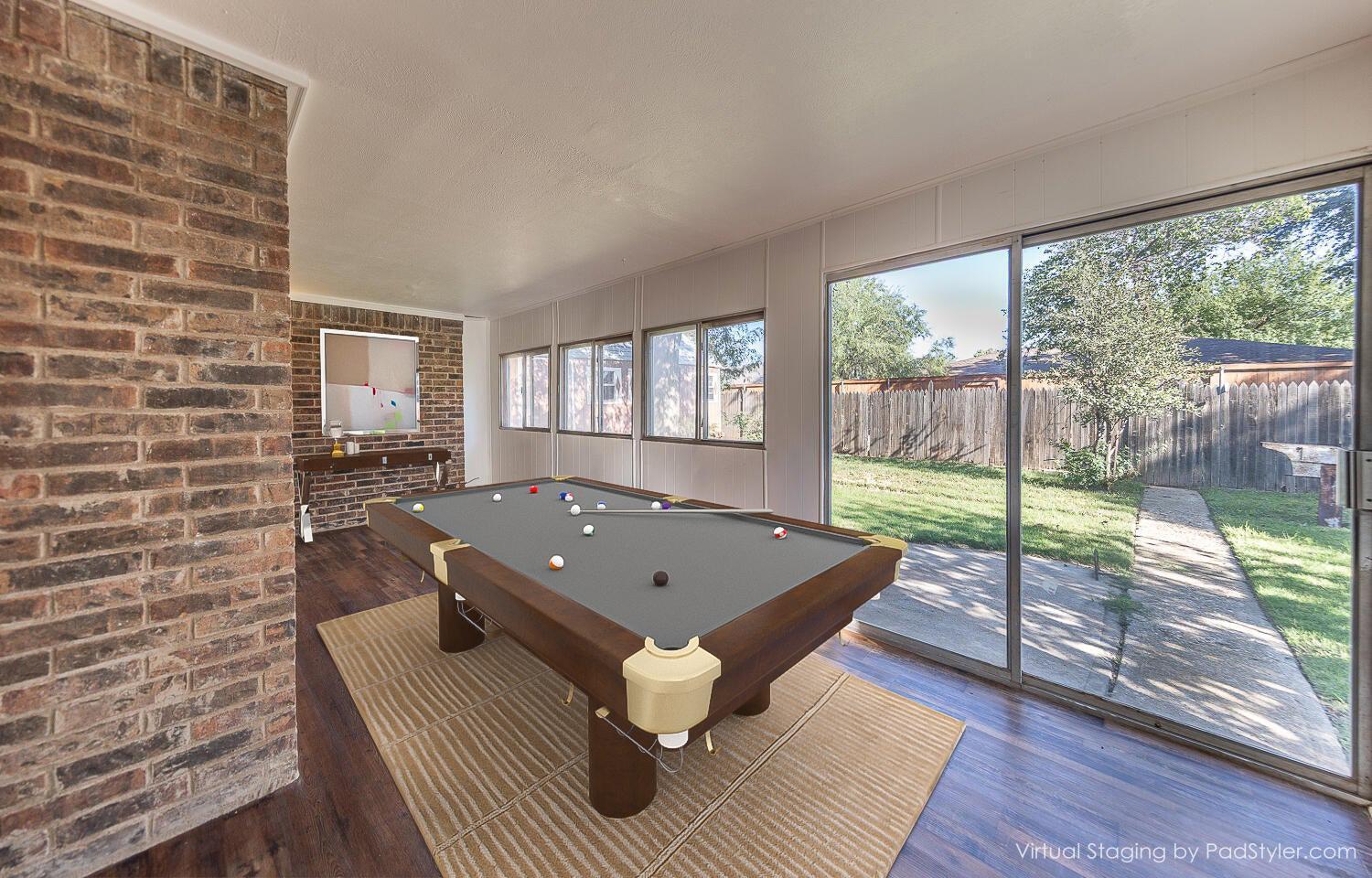 4706 78th Street Lubbock, TX 79424 - Photo 5 of 43 a living room with a floor to ceiling window and wooden floor