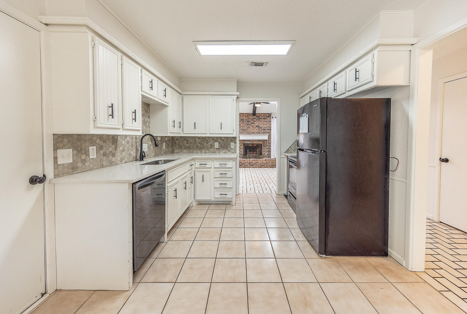 4706 78th Street Lubbock, TX 79424 - Photo 7 of 43 a kitchen with a refrigerator a sink and dishwasher