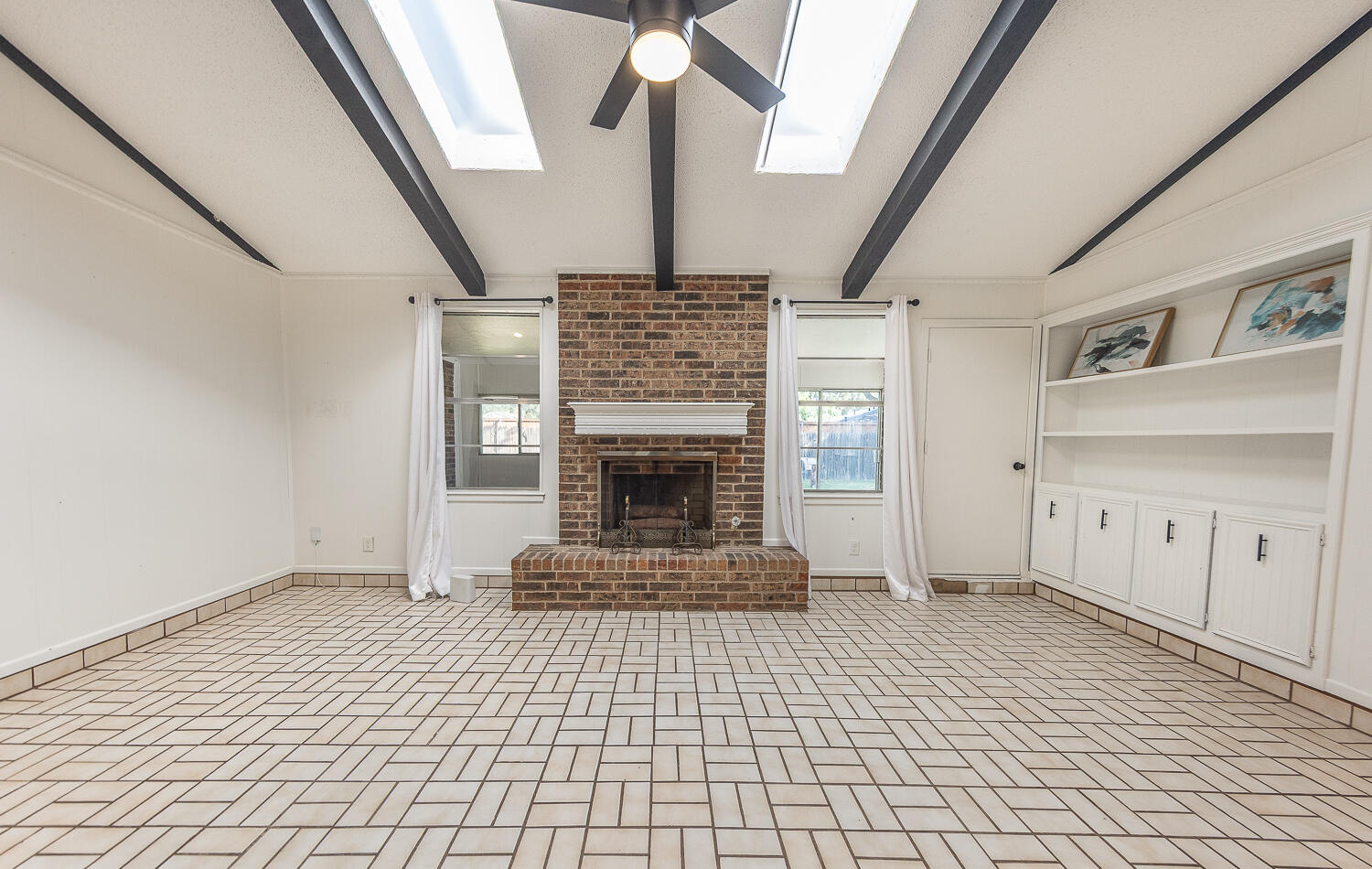 4706 78th Street Lubbock, TX 79424 - Photo 9 of 43 a view of an entryway with a fireplace