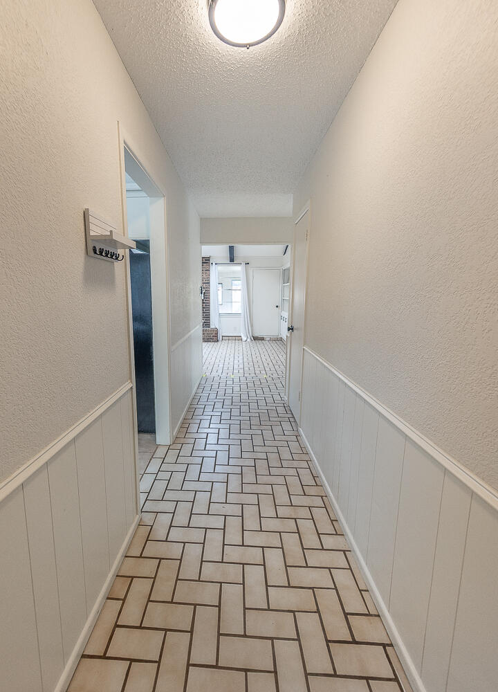 4706 78th Street Lubbock, TX 79424 - Photo 10 of 43 a view of a room with wooden floor and white walls