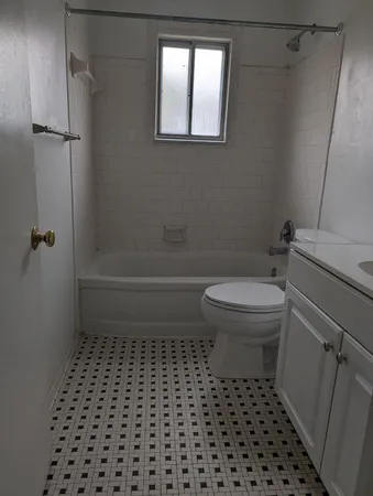 a bathroom with a toilet a sink and a shower