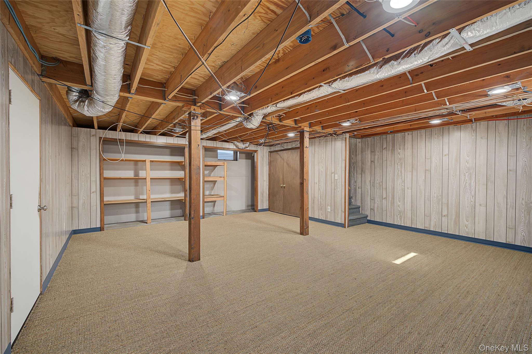 318 Cornwall Hill Road Patterson, NY 12563 - Photo 4 of 38 Finished basement area featuring wood paneling, exposed ceiling joists, and recessed lighting