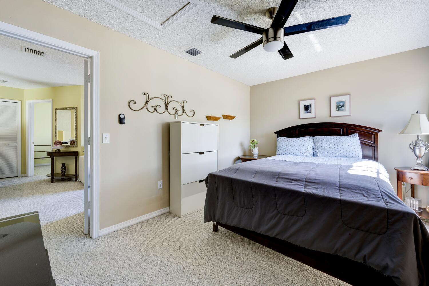 151 St Michaels Court Jupiter, FL 33458 - Photo 28 of 41 a bedroom with a bed and a chandelier