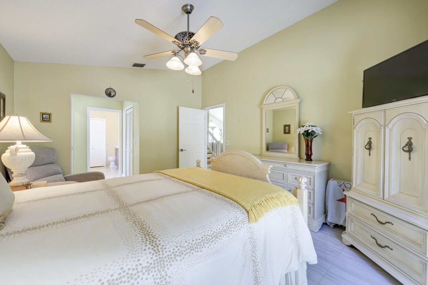 151 St Michaels Court Jupiter, FL 33458 - Photo 30 of 41 a bedroom with a bed and a chandelier