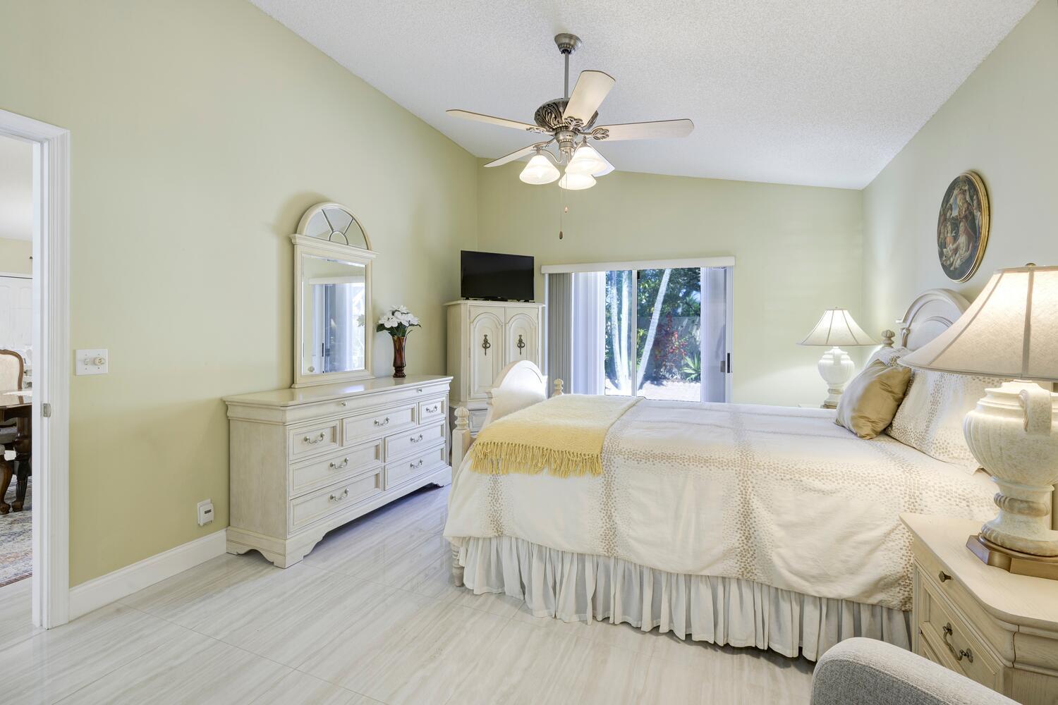 151 St Michaels Court Jupiter, FL 33458 - Photo 33 of 41 a bedroom with a bed and a chandelier