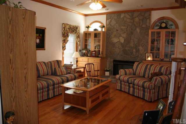99 Skinner Road Four Oaks, NC 27524 - Photo 3 of 10 Family rm boasts stone fireplace, built-in cabinets!!