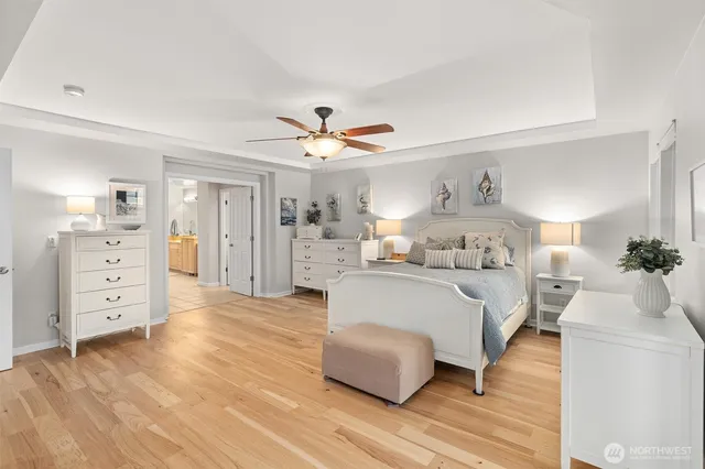 a bedroom with a large bed and a chandelier