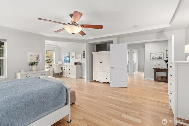 a room with a bed and ceiling fan