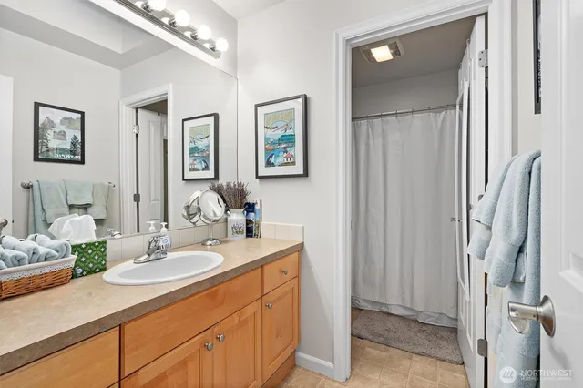 a bathroom with double vanity sinks a vanity and a mirror