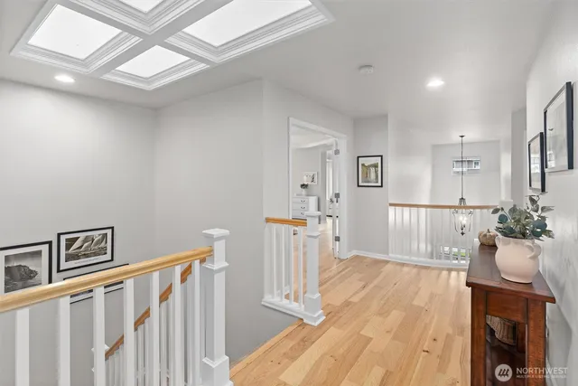 a view of a hallway to a livingroom with wooden floor