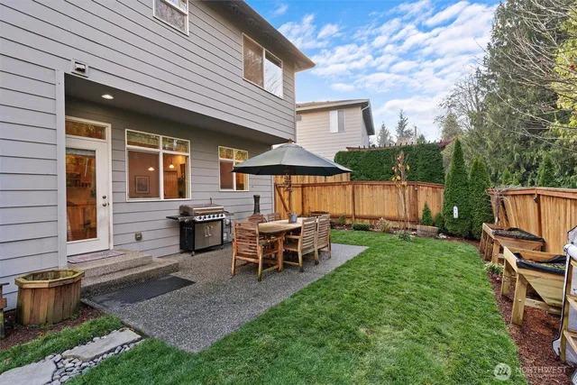 a view of a house with backyard sitting area and garden