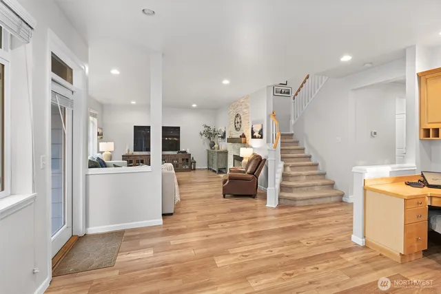 a living room with furniture and kitchen view