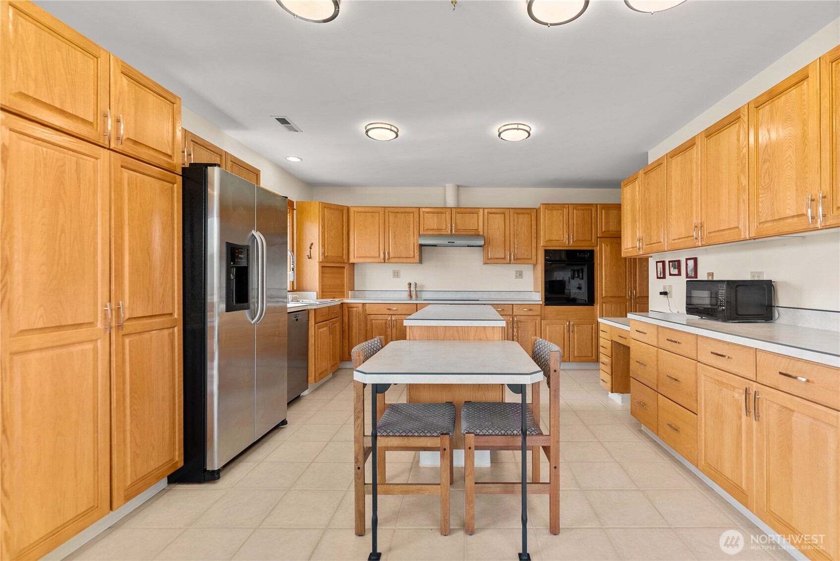 427 Rendezvous Road Winthrop, WA 98862 - Photo 21 of 40 a kitchen with stainless steel appliances kitchen island granite countertop a refrigerator and microwave