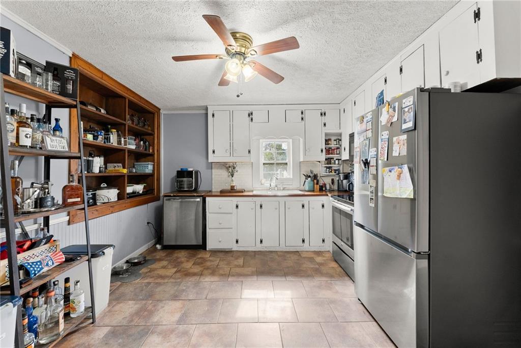 2000 Dr Bramblett Road Cumming, GA 30040 - Photo 11 of 37 a kitchen with stainless steel appliances a refrigerator and a cabinets