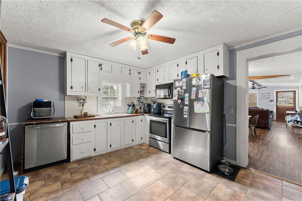 2000 Dr Bramblett Road Cumming, GA 30040 - Photo 12 of 37 a large kitchen with stainless steel appliances granite countertop a refrigerator and a sink