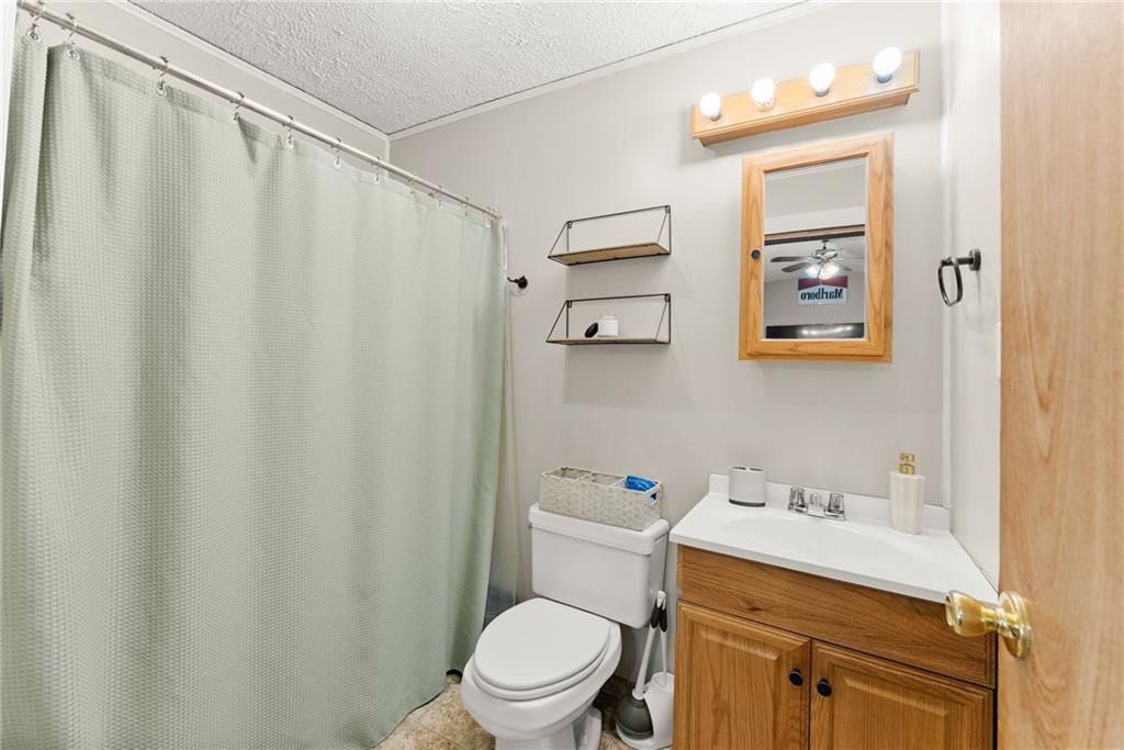 2000 Dr Bramblett Road Cumming, GA 30040 - Photo 17 of 37 a bathroom with a sink a toilet and shower curtain
