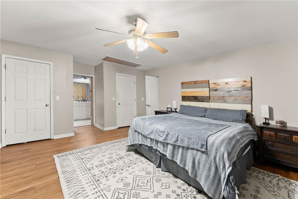 2000 Dr Bramblett Road Cumming, GA 30040 - Photo 19 of 37 a bedroom with a large bed and a chandelier