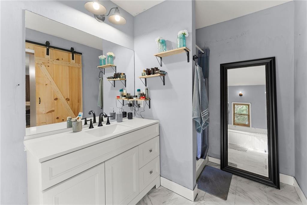 2000 Dr Bramblett Road Cumming, GA 30040 - Photo 22 of 37 a bathroom with a sink vanity and mirror
