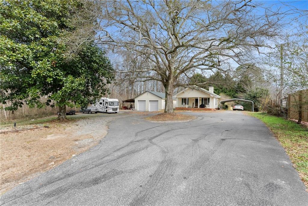 2000 Dr Bramblett Road Cumming, GA 30040 - Photo 29 of 37 a front view of a house with a yard and garage