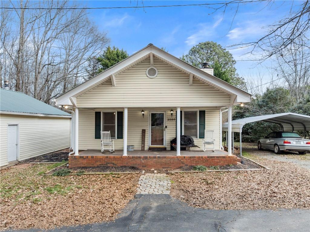 2000 Dr Bramblett Road Cumming, GA 30040 - Photo 3 of 37 a front view of a house with yard patio and fire pit
