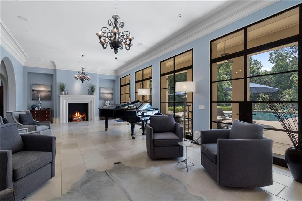 1500 West Wesley Road Northwest Atlanta, GA 30327 - Photo 11 of 60 a living room with furniture a fireplace and a chandelier