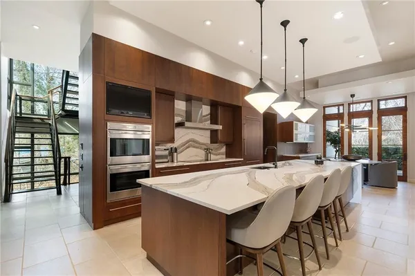 a large kitchen with a table and chairs in it