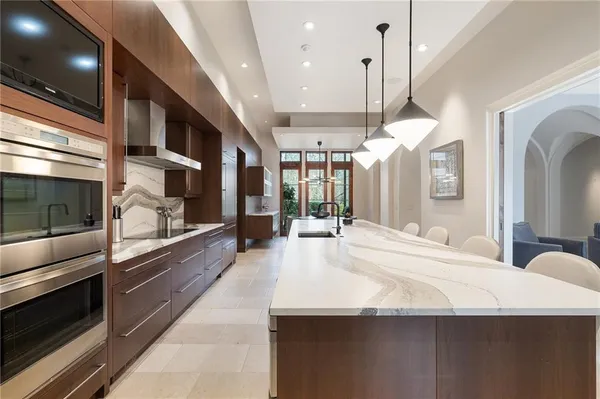 a kitchen with a stove a sink and a refrigerator