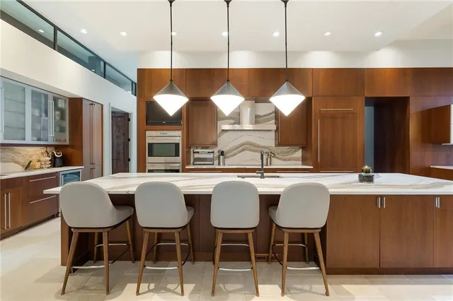 a dining room with furniture and a floor to ceiling window
