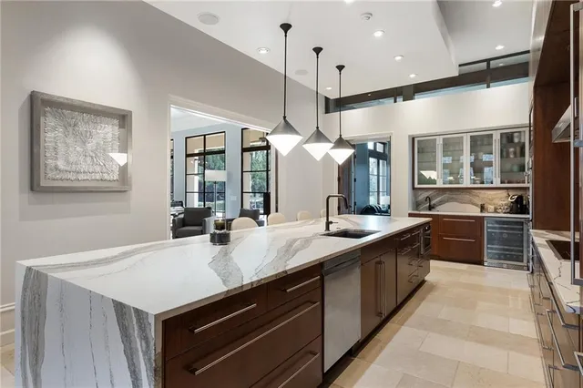 a living room with furniture a fireplace and a large window