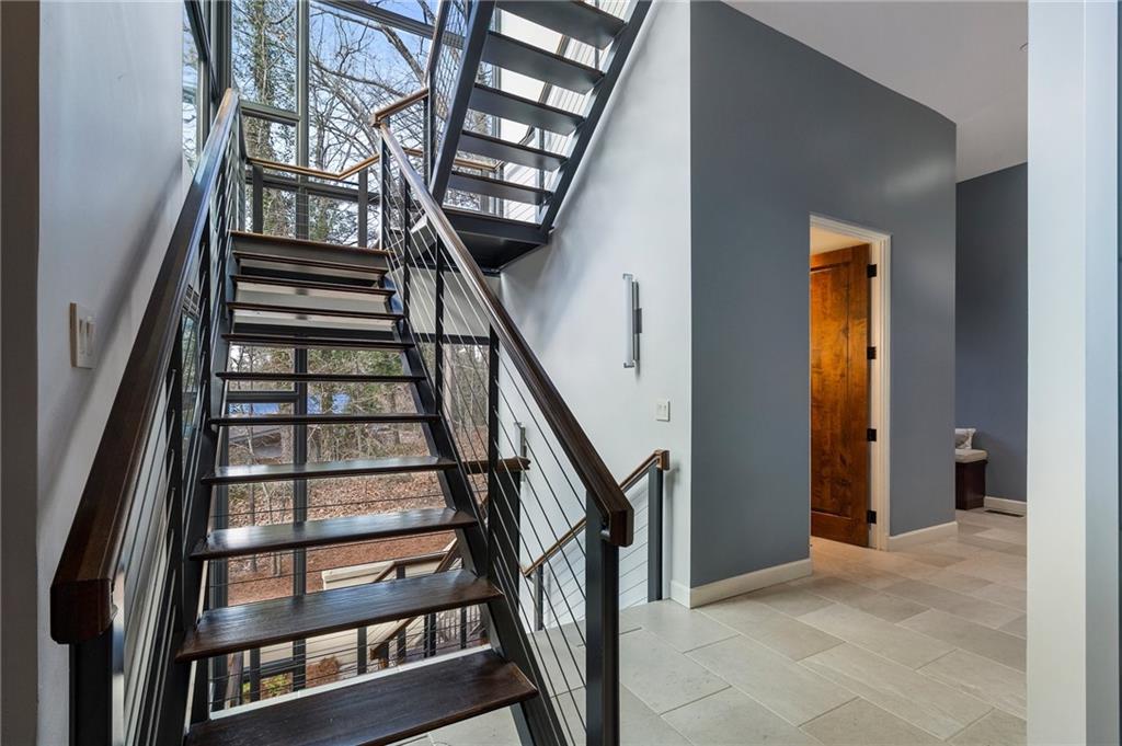 1500 West Wesley Road Northwest Atlanta, GA 30327 - Photo 24 of 60 a view of staircase with lots of frames on wall and a window