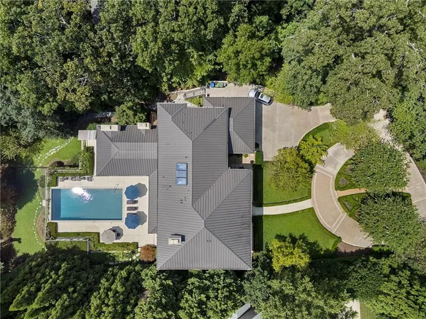 an aerial view of a house with a swimming pool