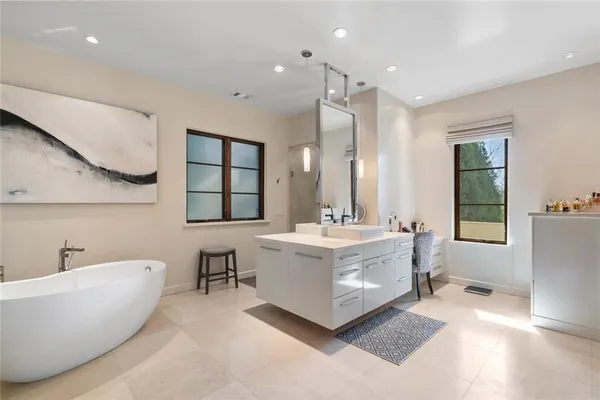 a spacious bedroom with a bed and large windows