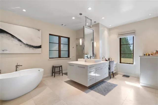 a spacious bedroom with a bed and large windows