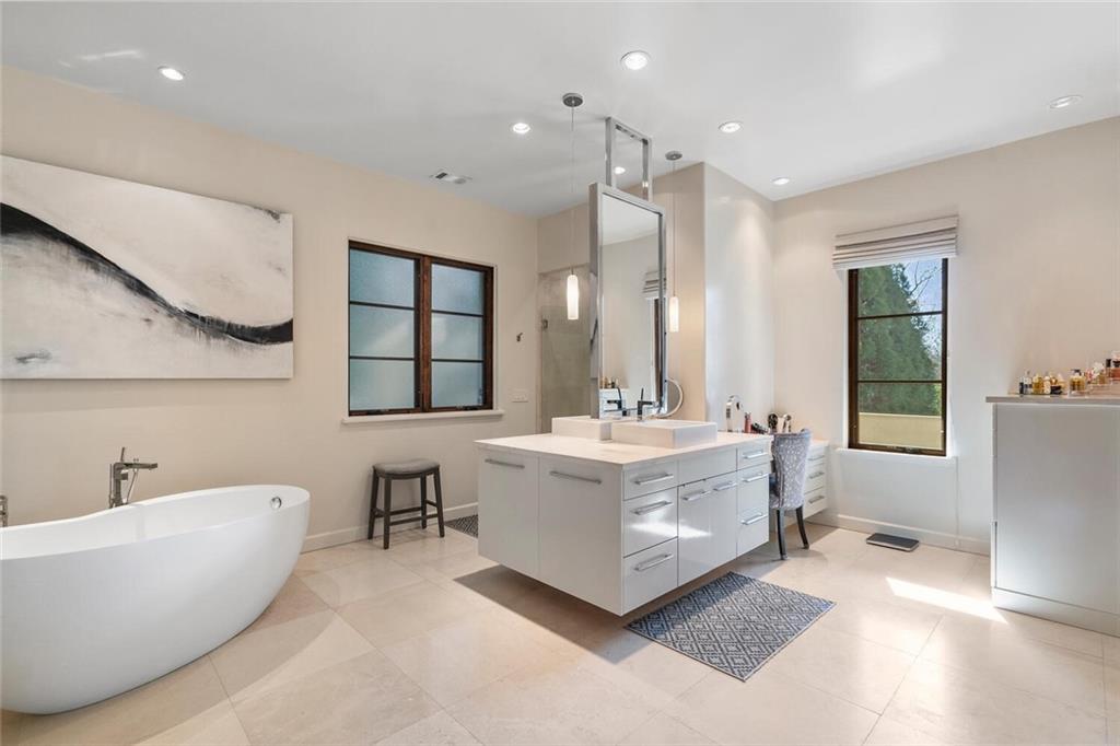 1500 West Wesley Road Northwest Atlanta, GA 30327 - Photo 32 of 60 a bathroom with a tub a double vanity sink and mirror