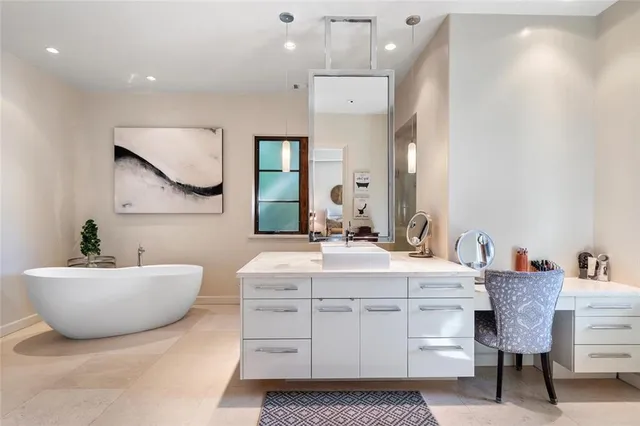 a spacious bathroom with a shower sink and mirror