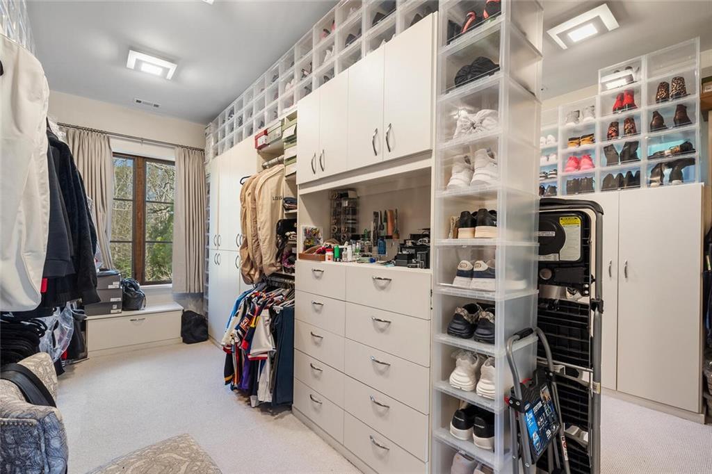 1500 West Wesley Road Northwest Atlanta, GA 30327 - Photo 34 of 60 a view of walk in closet with clothes and shoes