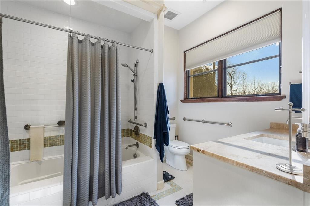 1500 West Wesley Road Northwest Atlanta, GA 30327 - Photo 36 of 60 a bathroom with a granite countertop sink a mirror and a bathtub