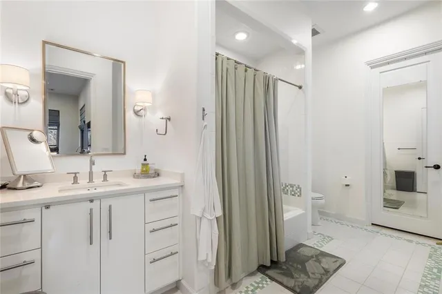 a bedroom with a bed and a potted plant